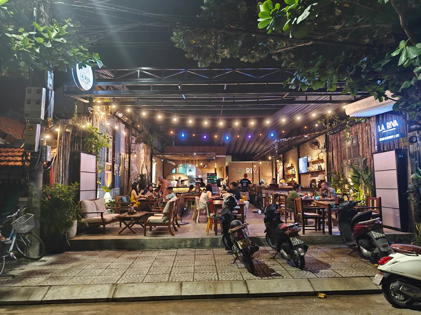 La Riva sits along An Bang Beach with an open-air layout and a relaxed seaside vibe